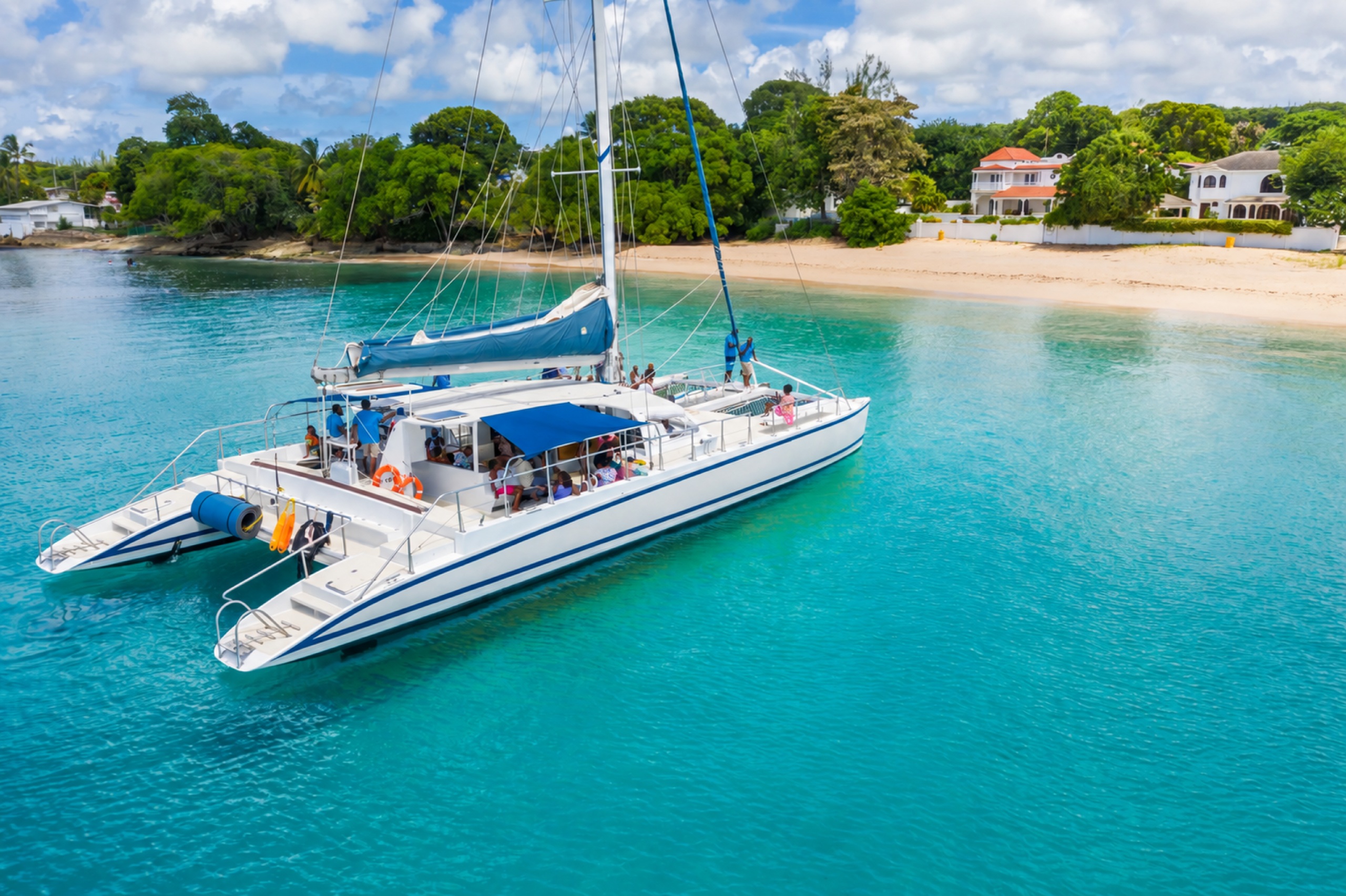 Catamaran on turquoise water beside the Barbados coast